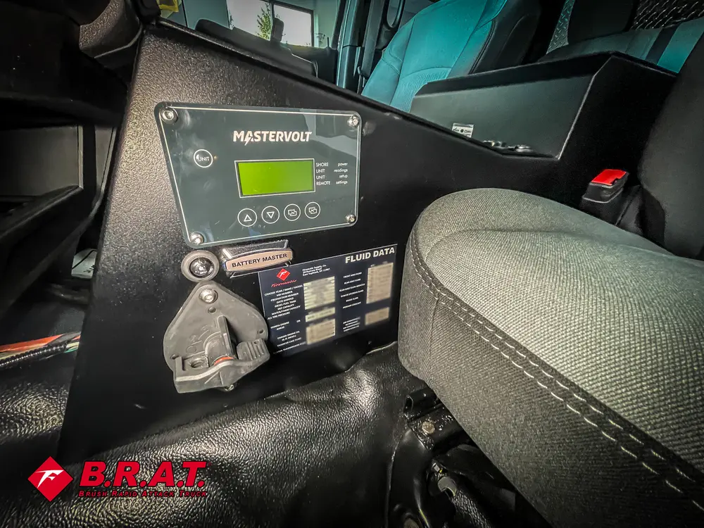 Pump control module mounted behind front seats near floor.