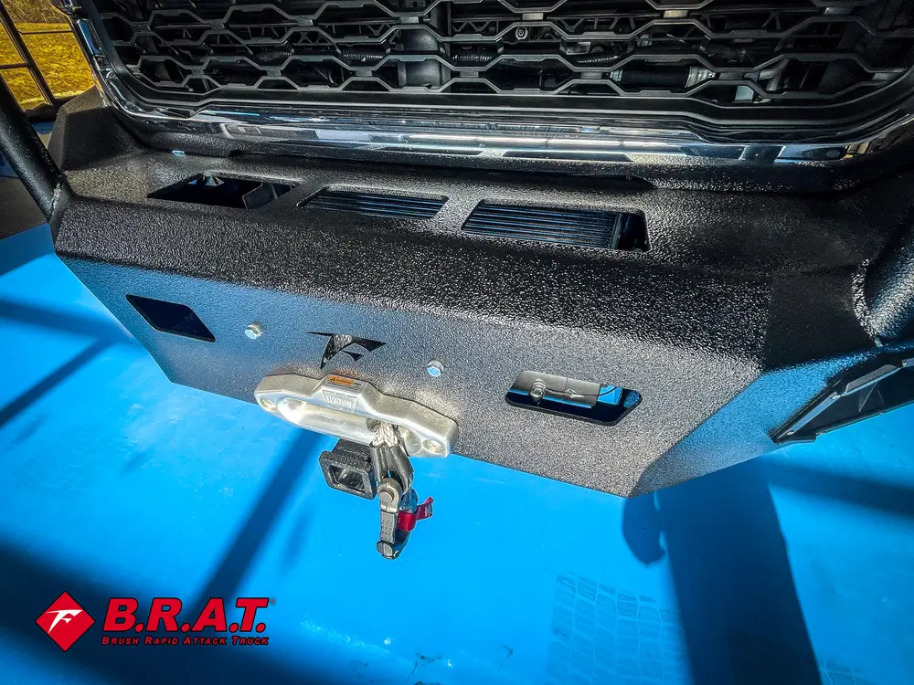 Front bumper close-up showing winch hook and fairlead.