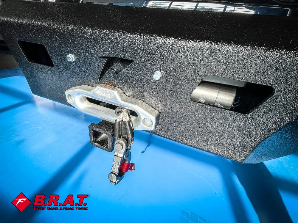 Winch hook mounted on textured front bumper face.