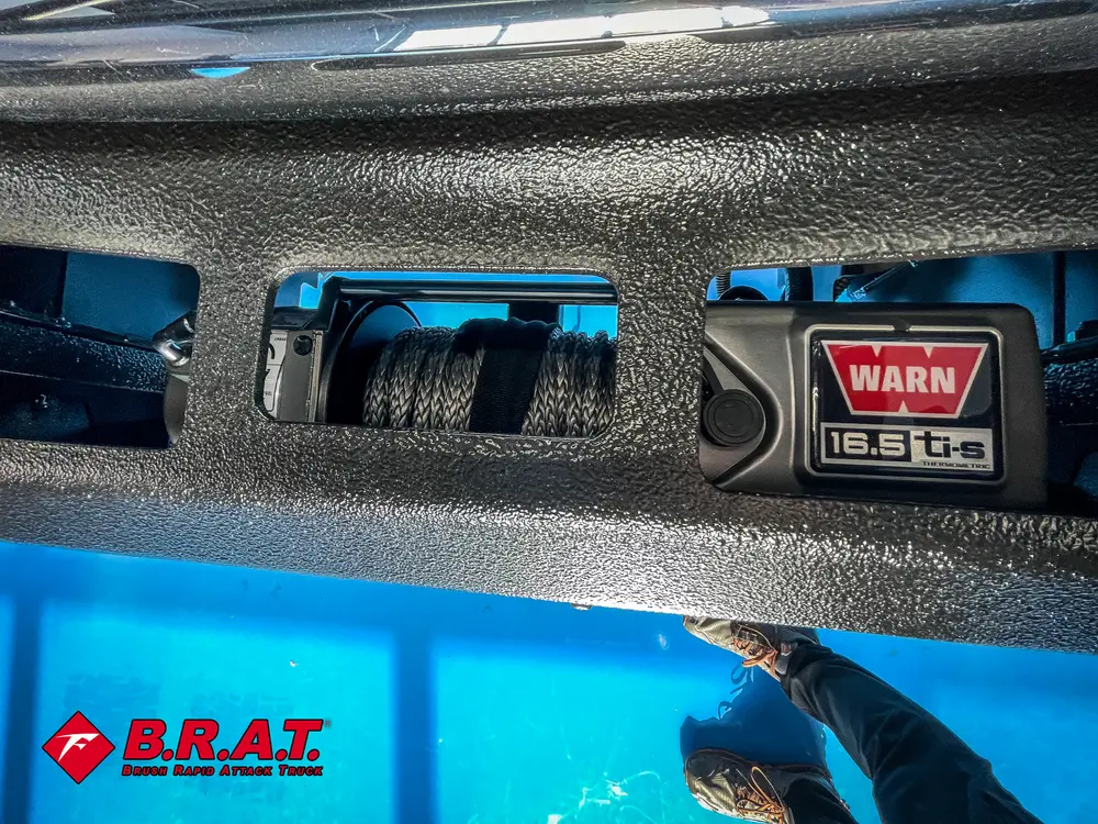 Front bumper opening with visible winch cable spool.