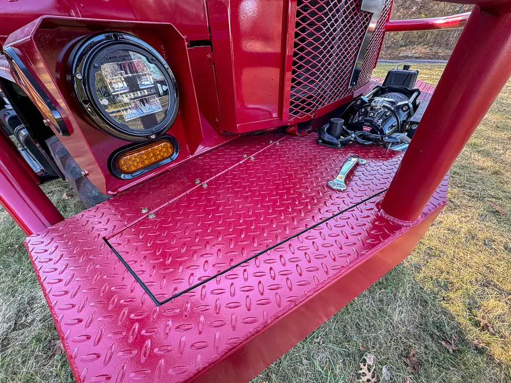 Front left corner close-up showing headlight and bumper step panel.