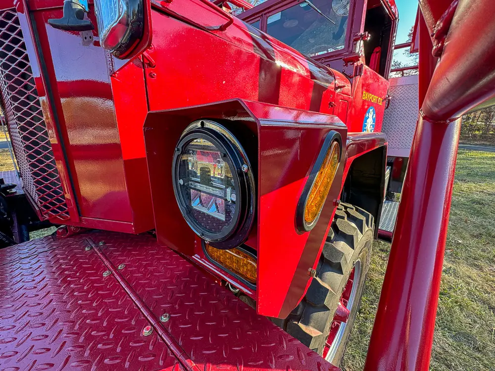 Front left headlight and bumper corner close-up.