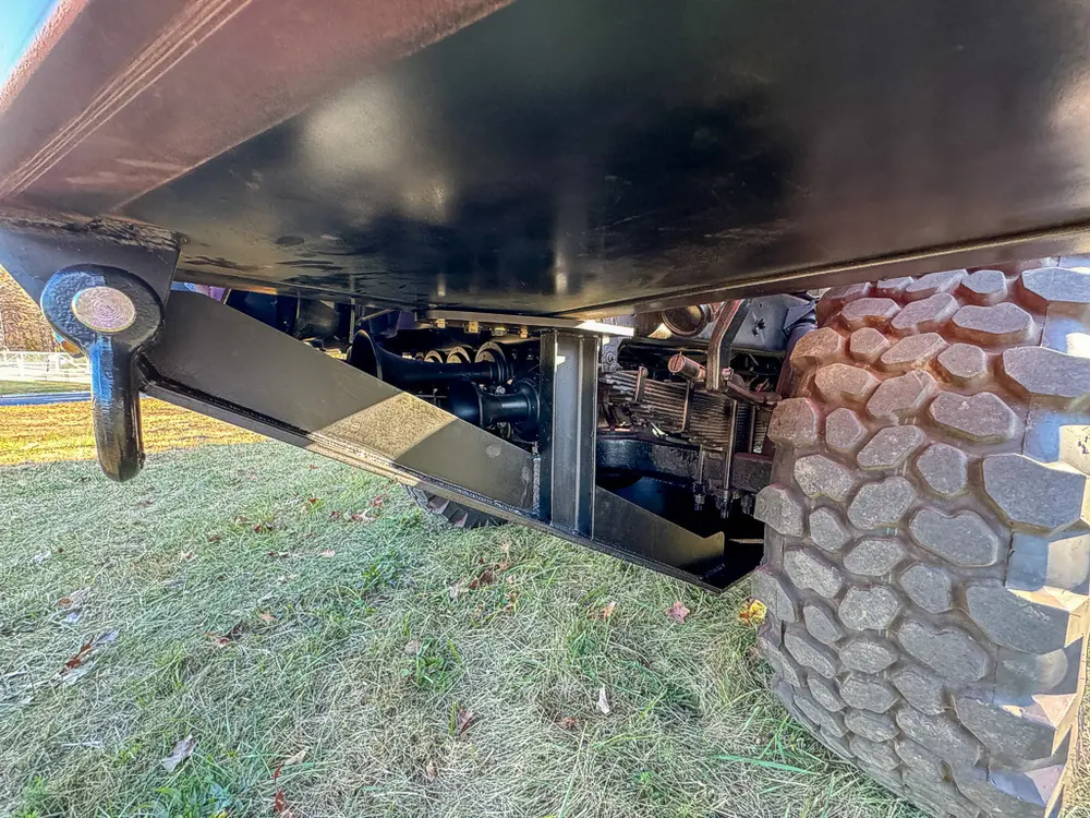 Undercarriage side view showing frame rails and rear tire area.