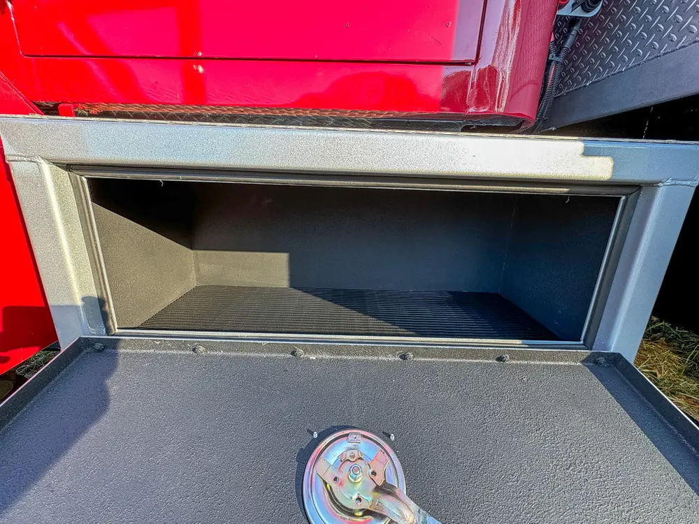 Open lower side compartment with empty storage interior.