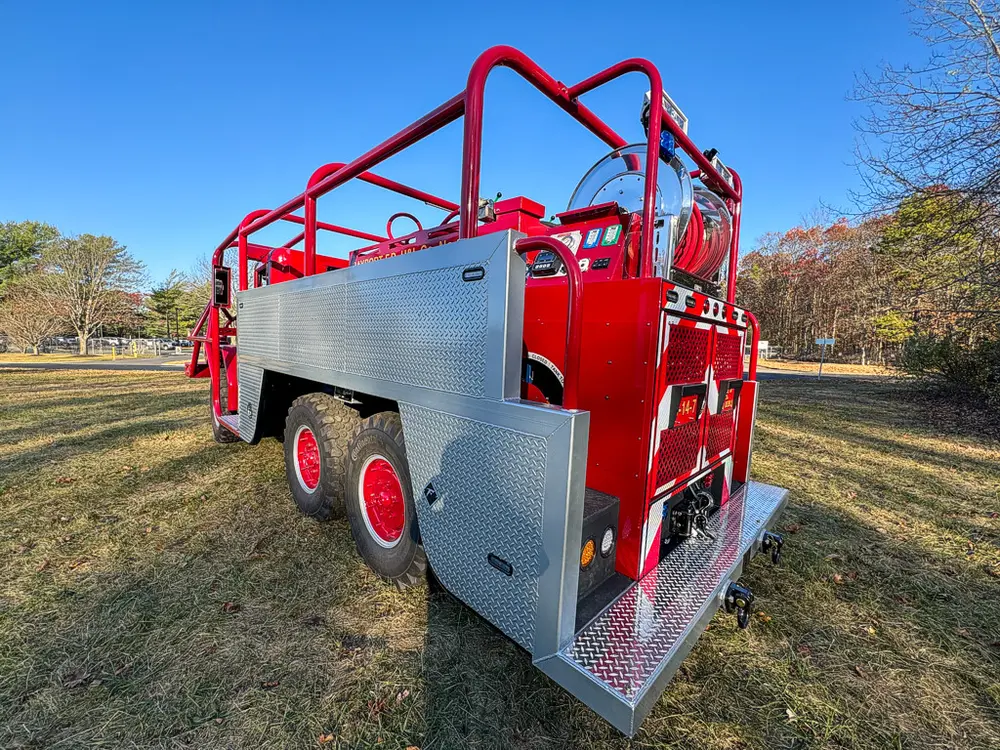 Rear-right three-quarter view with side rail framework and rear step.