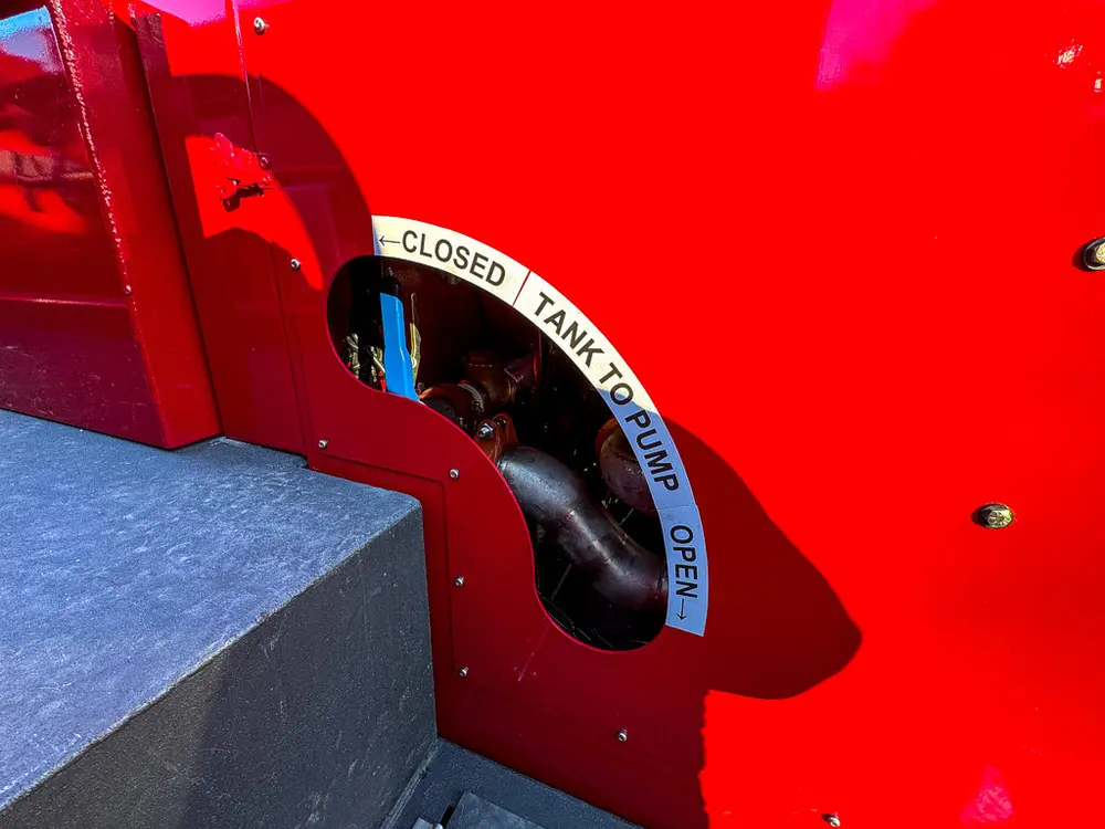 Close-up of side body marking near the closed tank-to-pump lever label.