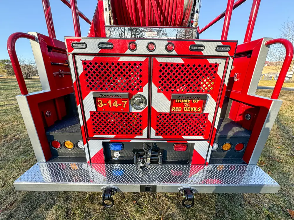 Straight rear view with mesh doors and platform step.