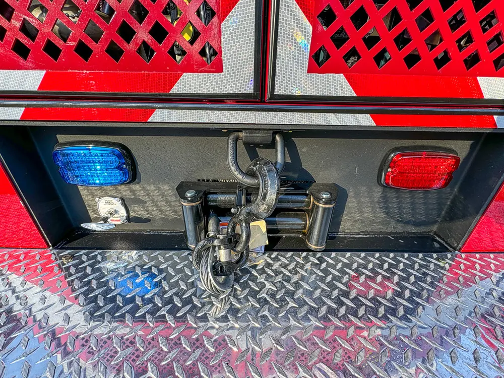 Rear bumper corner close-up with hitch and taillight housing.