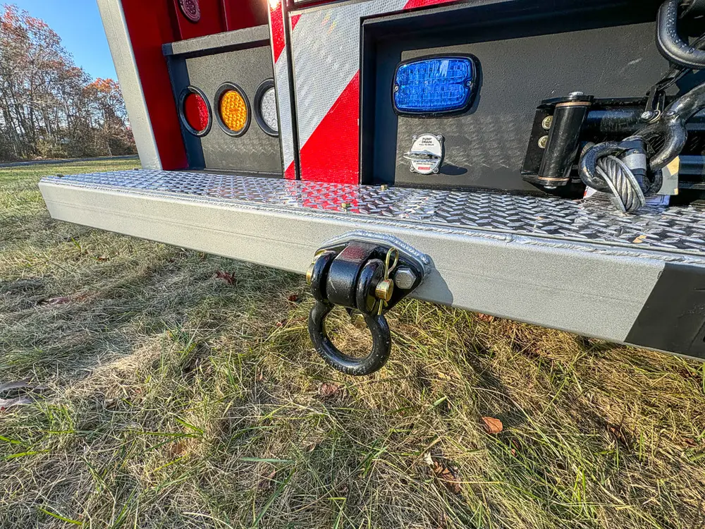 Rear step and tow ring close-up from the left side.