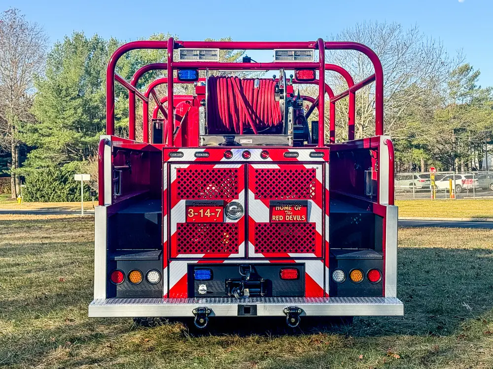 Straight rear view with chevron panel and hose reel at top.