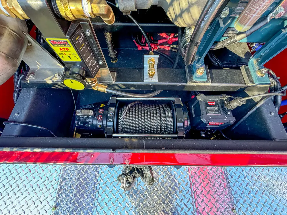 Top rear compartment view with mounted winch cable spool and electronics.