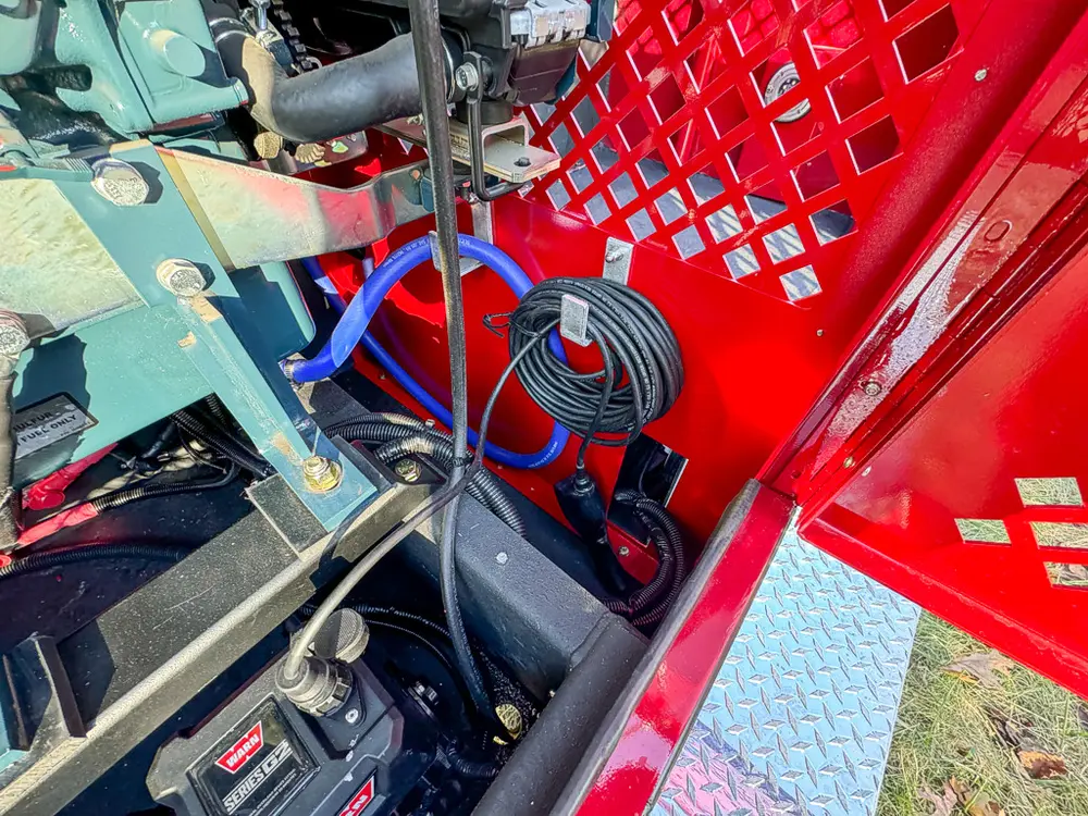 Top bay close-up showing fan and control equipment beside the hose reel.
