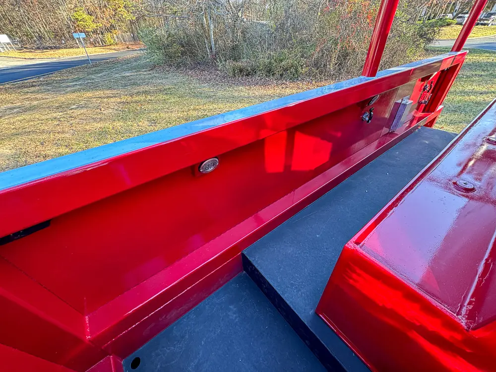 Open top-side storage trough with long black floor panel.