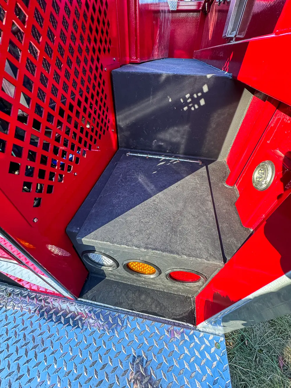Small rear-side cubby with mesh panel and empty interior.