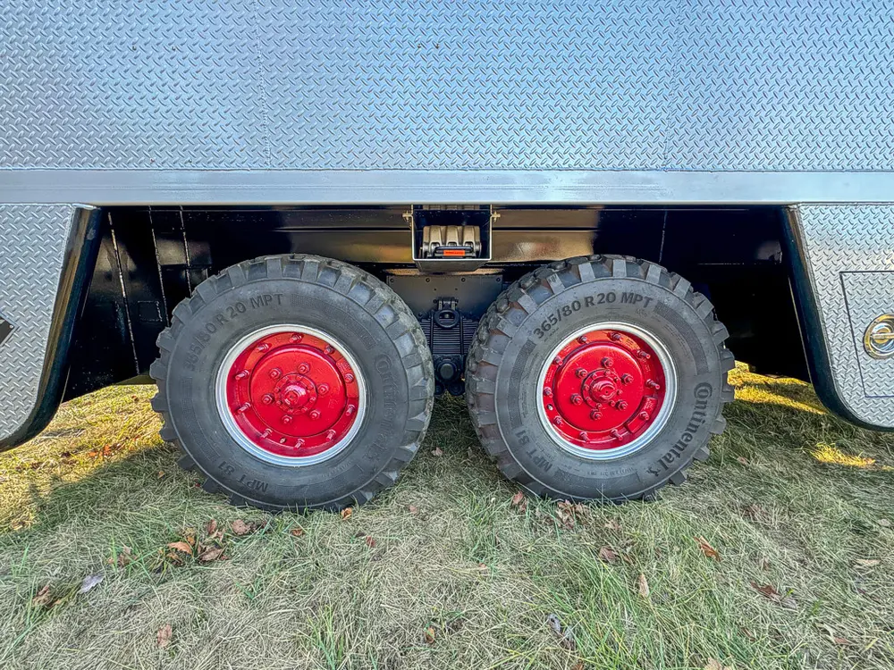 Tandem rear wheel close-up beneath the side body.