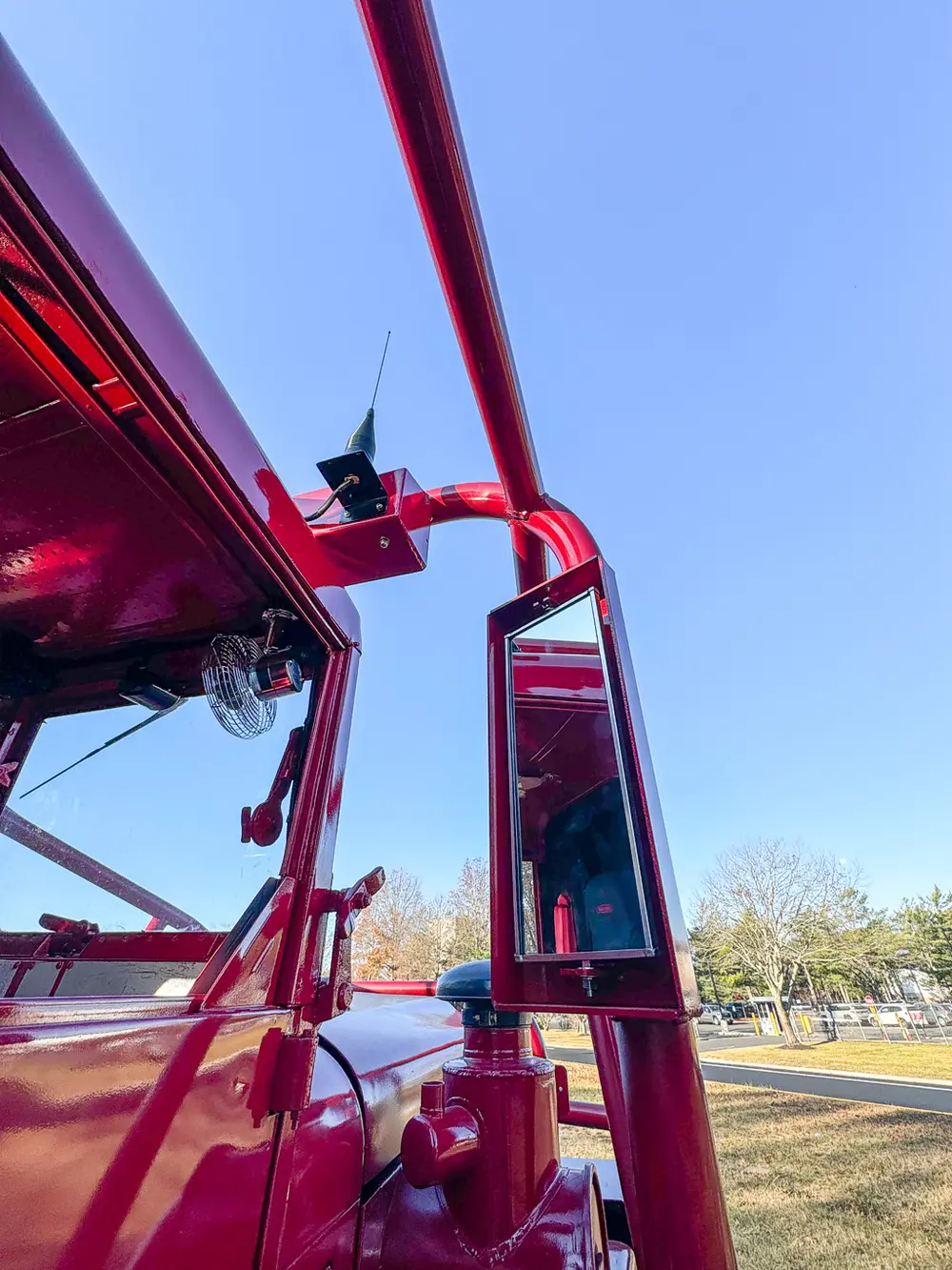Underside mirror or camera mount close-up near upper rail.