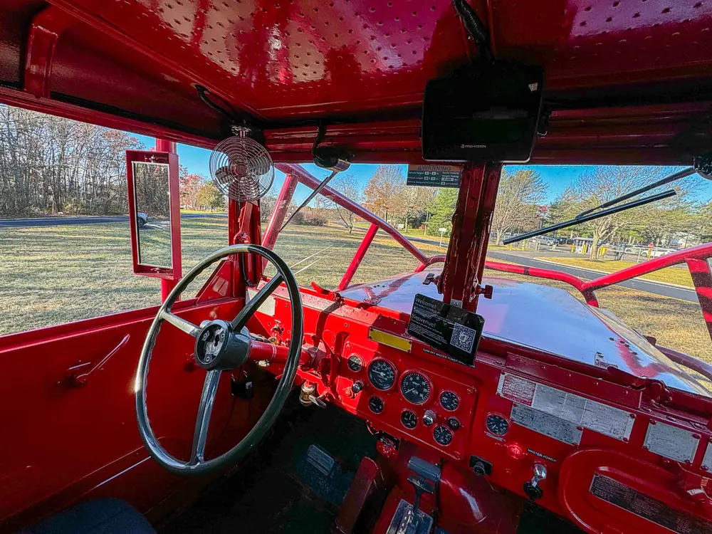 Wide cab interior showing dual controls and front dashboard.