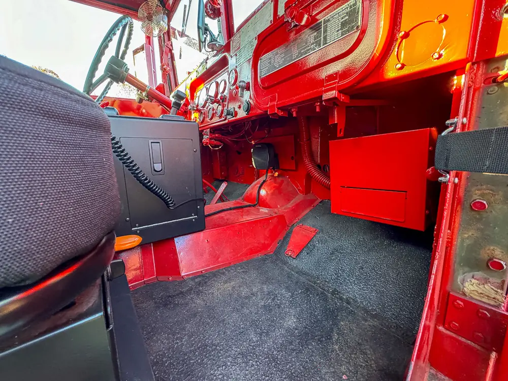 Passenger-side footwell and center tunnel controls close-up.