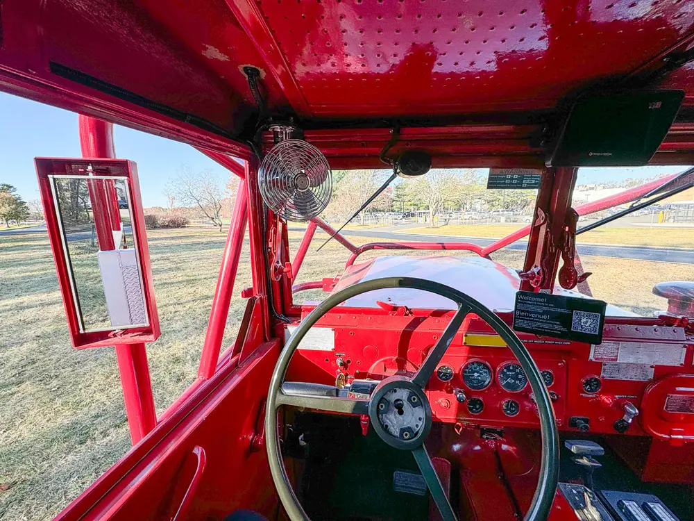Wide forward interior view showing both steering wheels and dash.