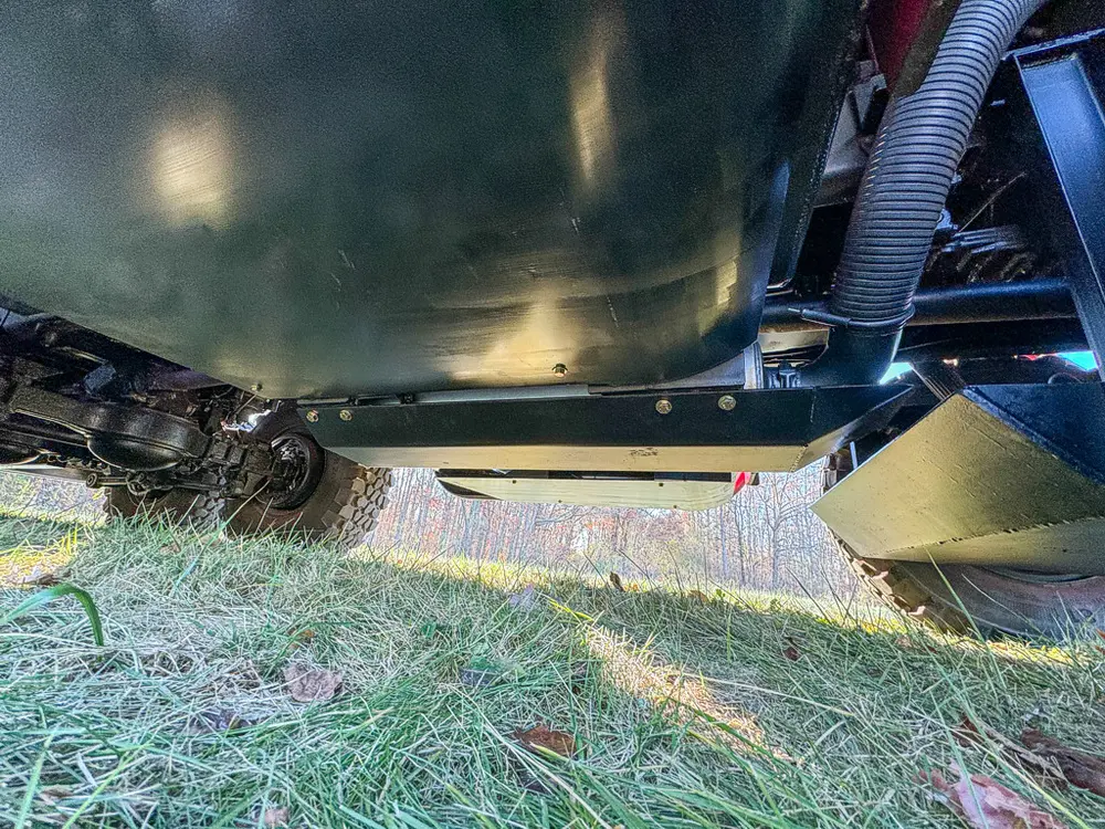 Lower underbody close-up with tank and frame components.