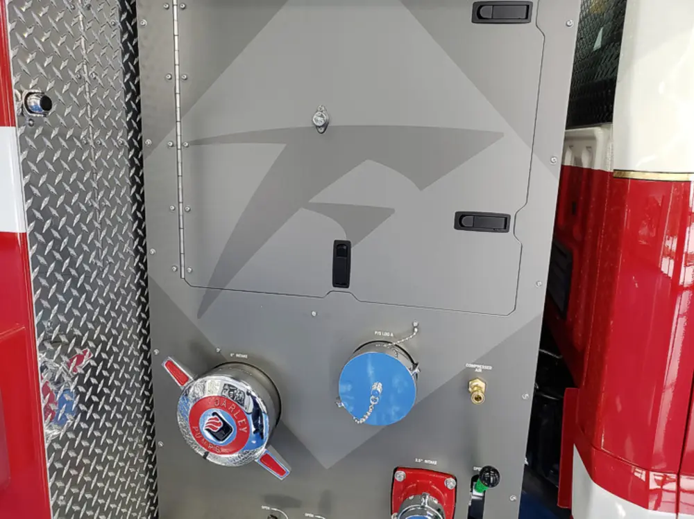 Exterior view of small fire truck showing cab, body compartments, and wheel/tire area.