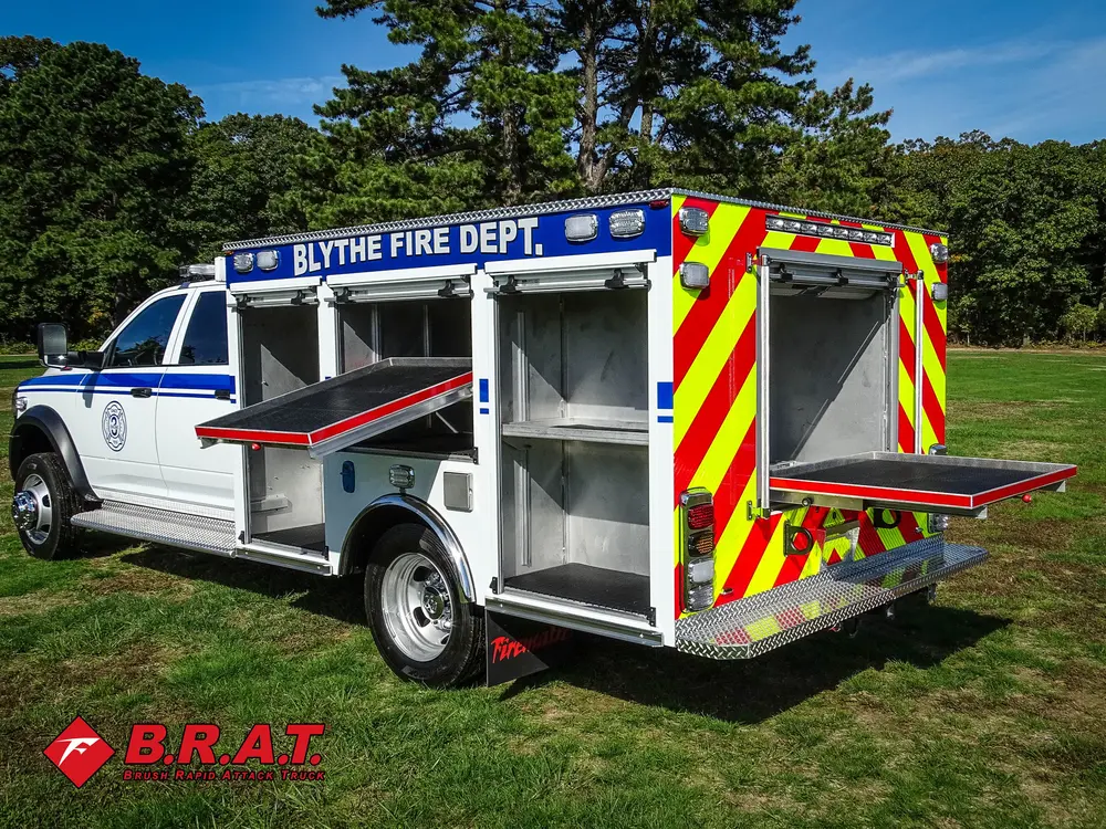 Exterior view of small fire truck showing cab, body compartments, and wheel/tire area.