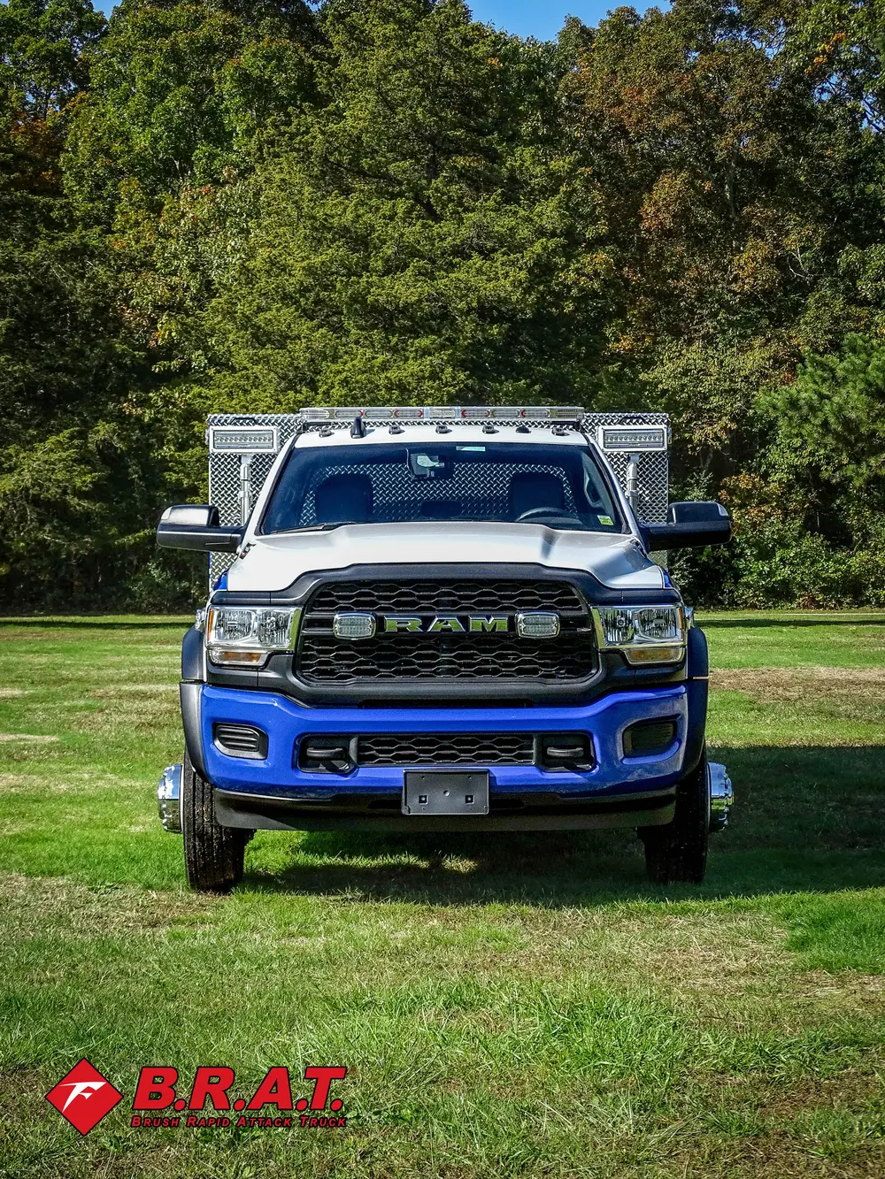 Exterior view of small fire truck showing cab, body compartments, and wheel/tire area.
