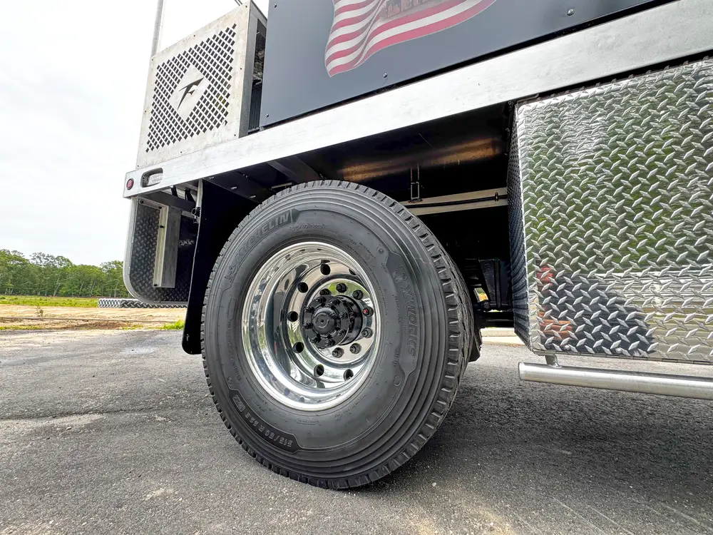 Wheel, tire, and suspension detail on apparatus, photo 268 of 303.