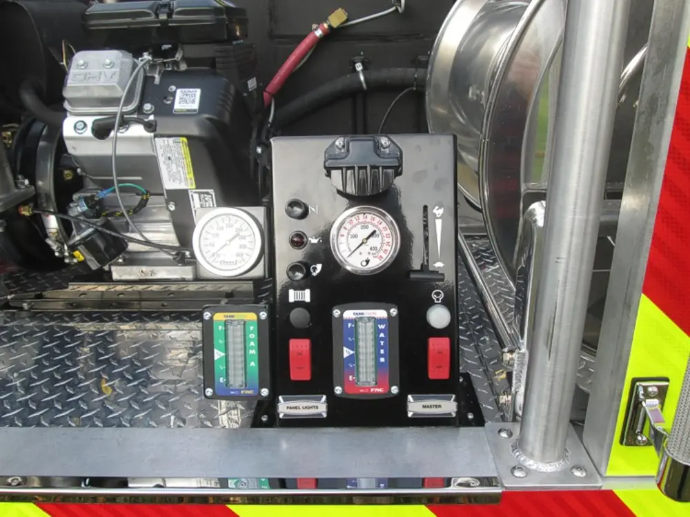 Exterior view of small fire truck showing cab, body compartments, and wheel/tire area.