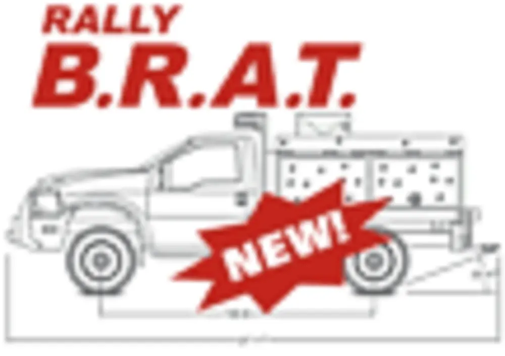 Exterior view of small fire truck showing cab, body compartments, and wheel/tire area.