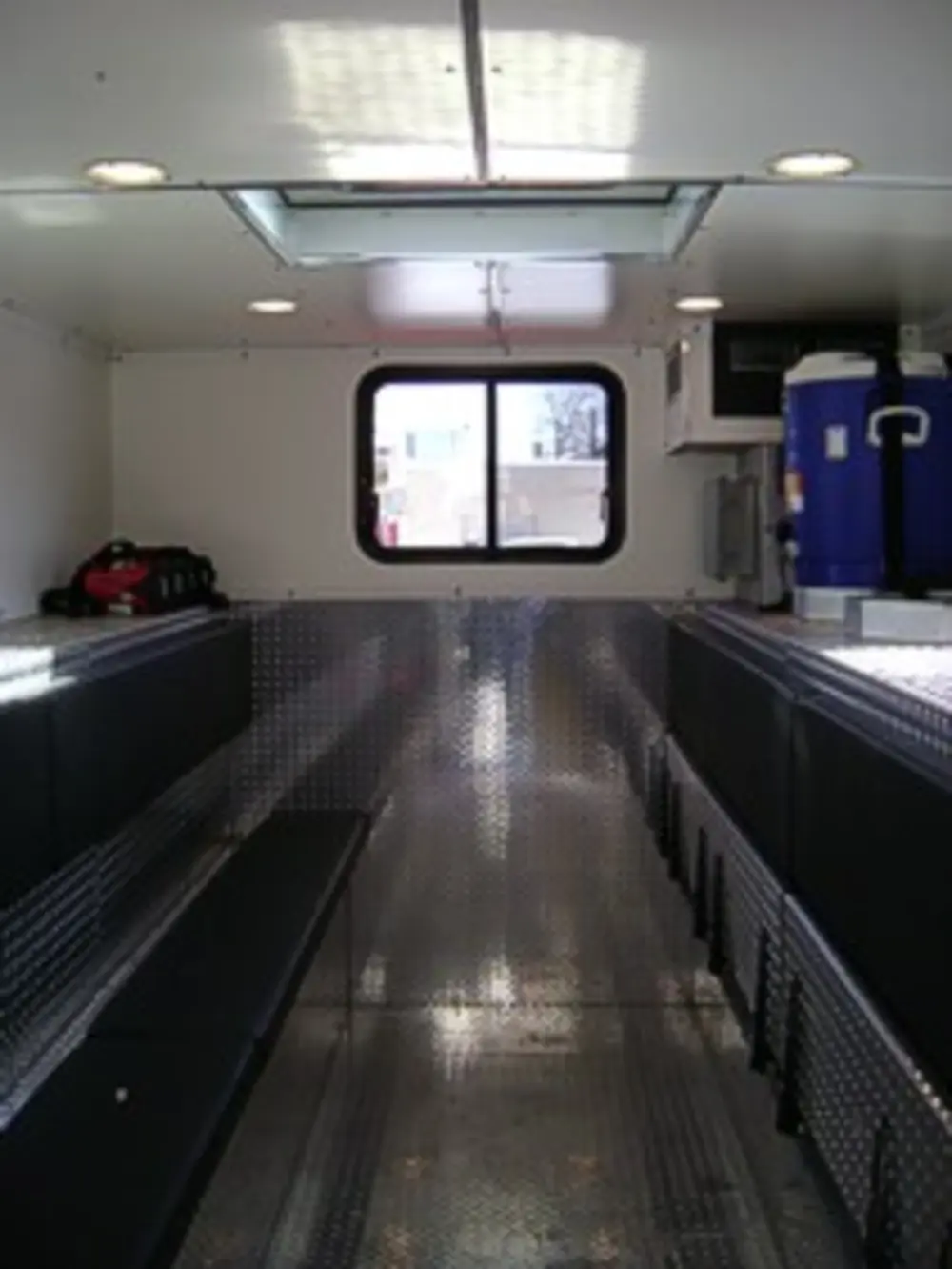 Driver-side rear angle highlighting side body compartments.