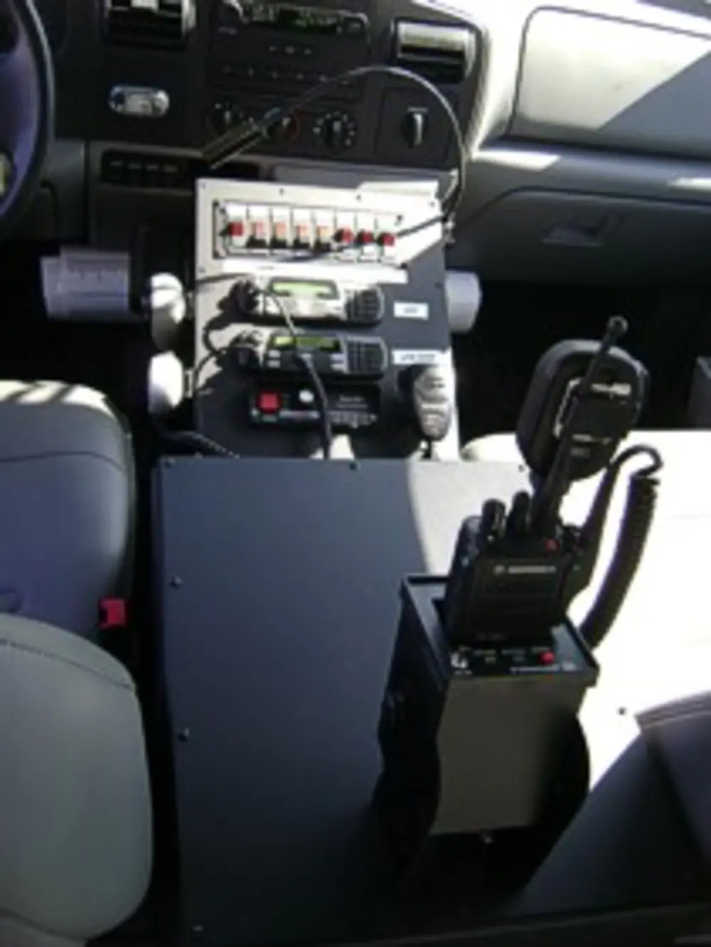 Cab interior view with dashboard, steering wheel, and front seats.