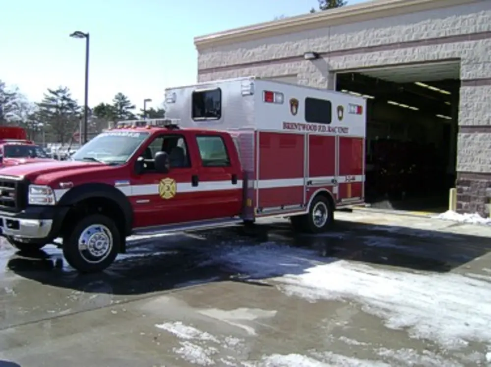 Driver-side profile of rehab unit parked near station bay.