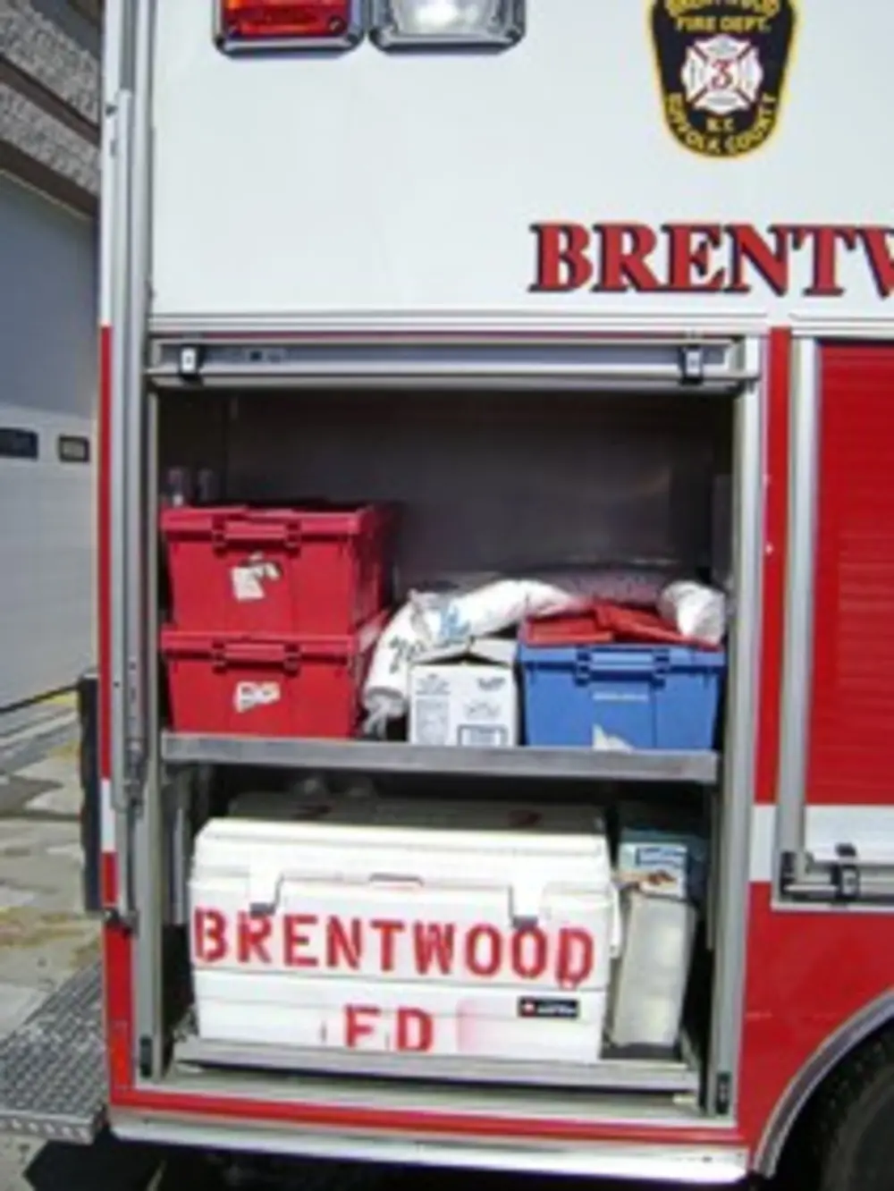 Open rear doors showing interior shelving and aisle.