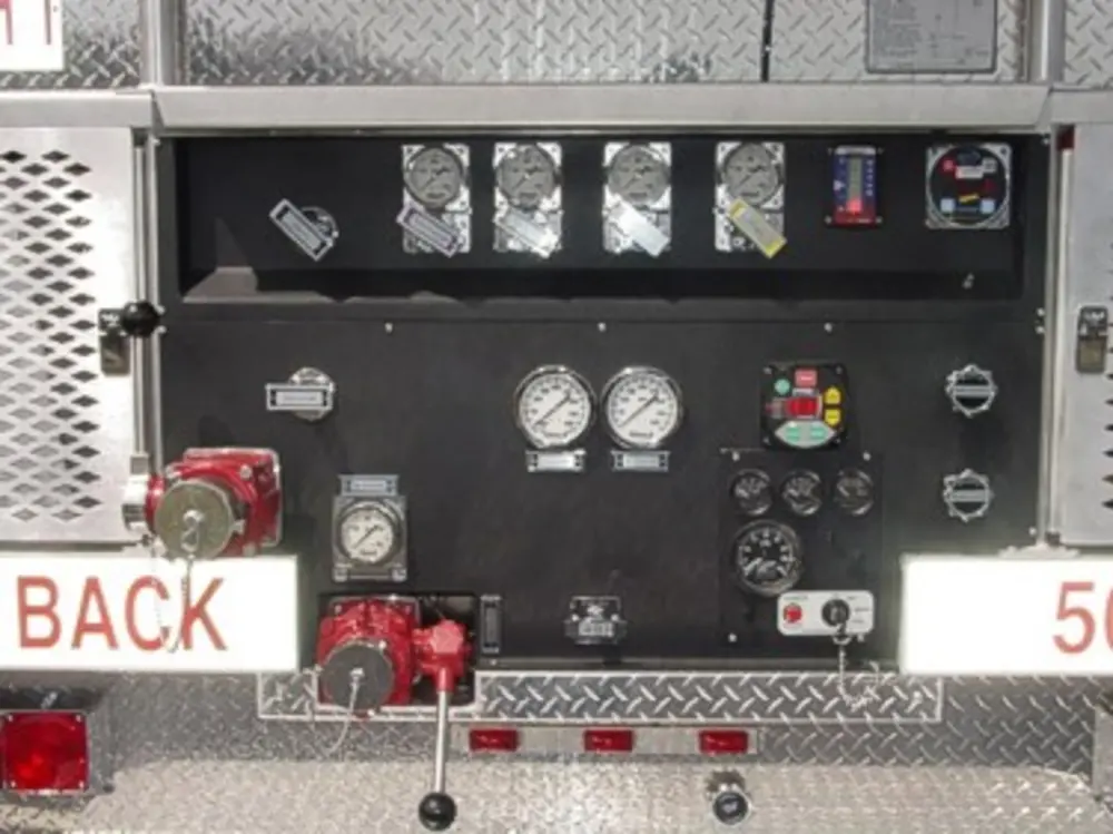 Exterior view of small fire truck showing cab, body compartments, and wheel/tire area.