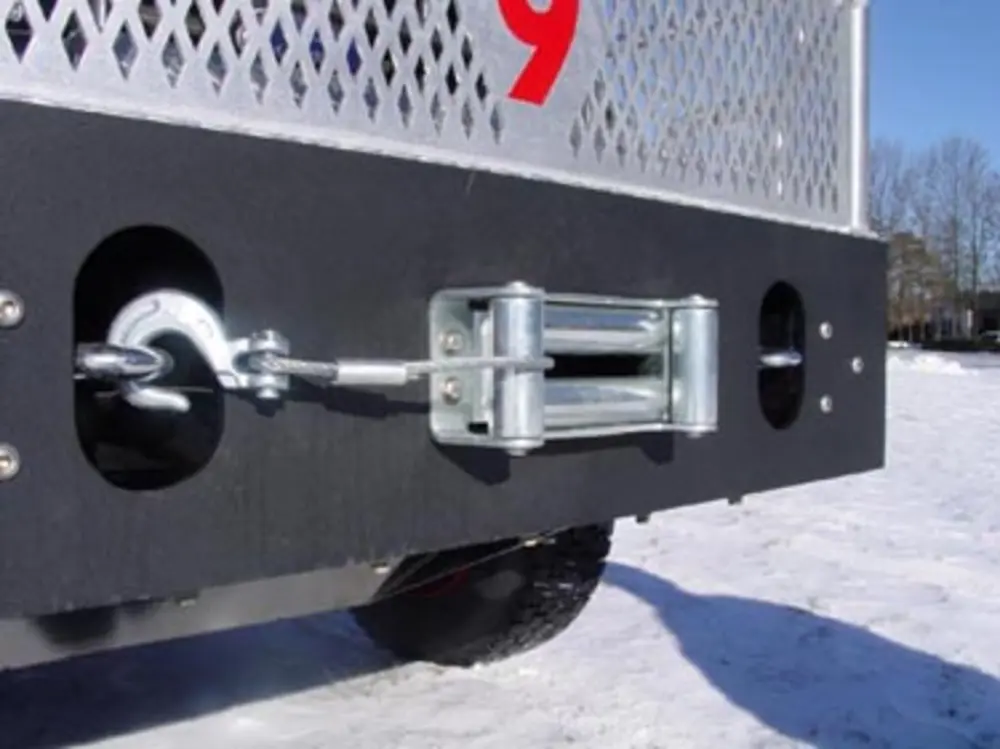 Exterior view of small fire truck showing cab, body compartments, and wheel/tire area.