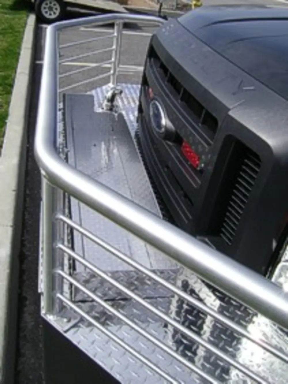 Exterior view of small fire truck showing cab, body compartments, and wheel/tire area.