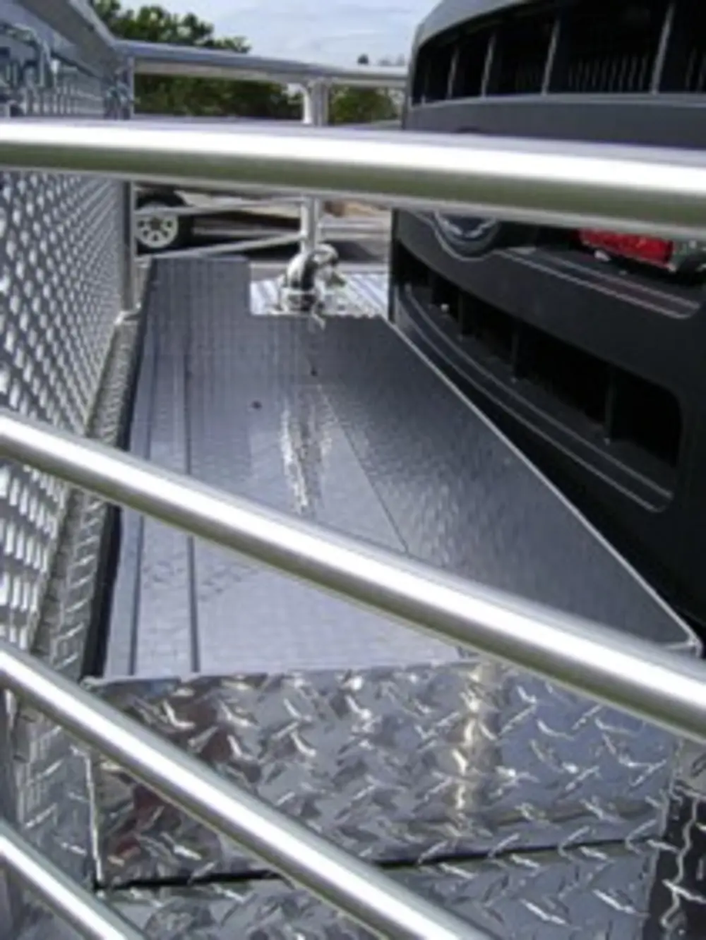 Exterior view of small fire truck showing cab, body compartments, and wheel/tire area.