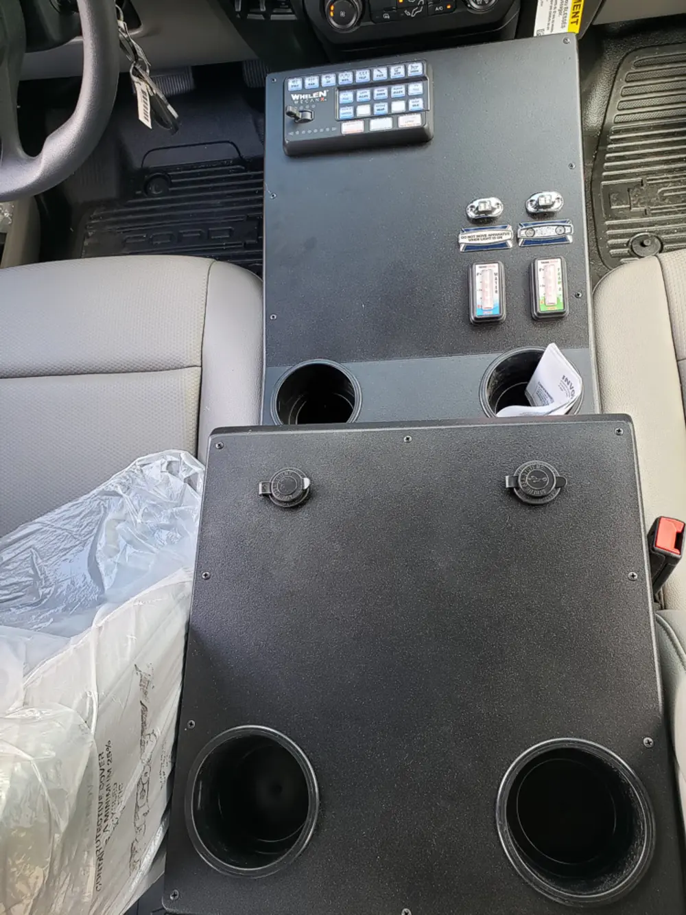 Exterior view of small fire truck showing cab, body compartments, and wheel/tire area.