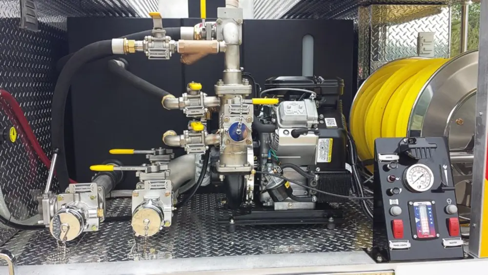 Exterior view of small fire truck showing cab, body compartments, and wheel/tire area.