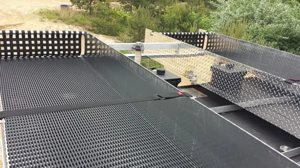 Exterior view of small fire truck showing cab, body compartments, and wheel/tire area.