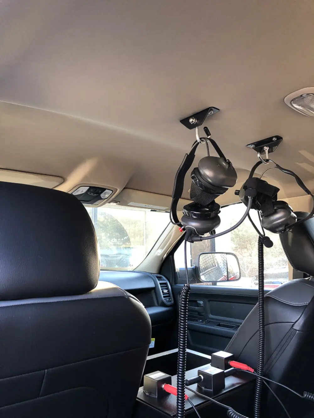 Exterior view of small fire truck showing cab, body compartments, and wheel/tire area.