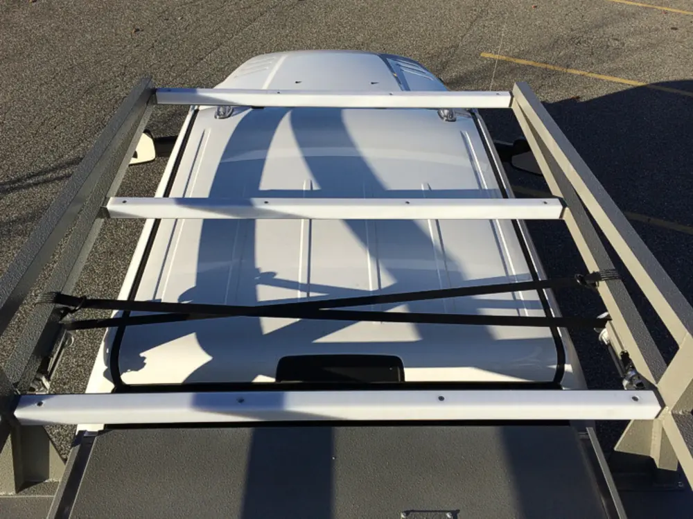 Exterior view of small fire truck showing cab, body compartments, and wheel/tire area.