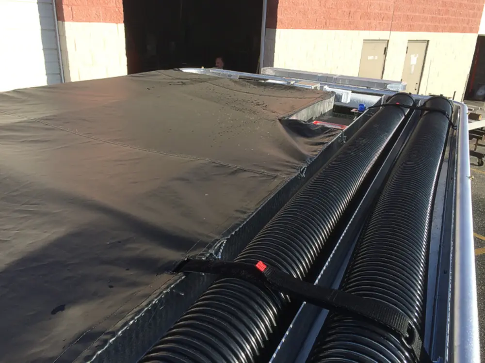 Exterior view of small fire truck showing cab, body compartments, and wheel/tire area.