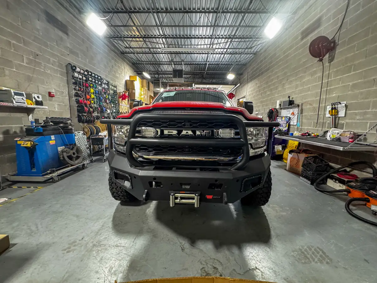 Straight-on front view showing the grille guard, bumper, and winch opening.
