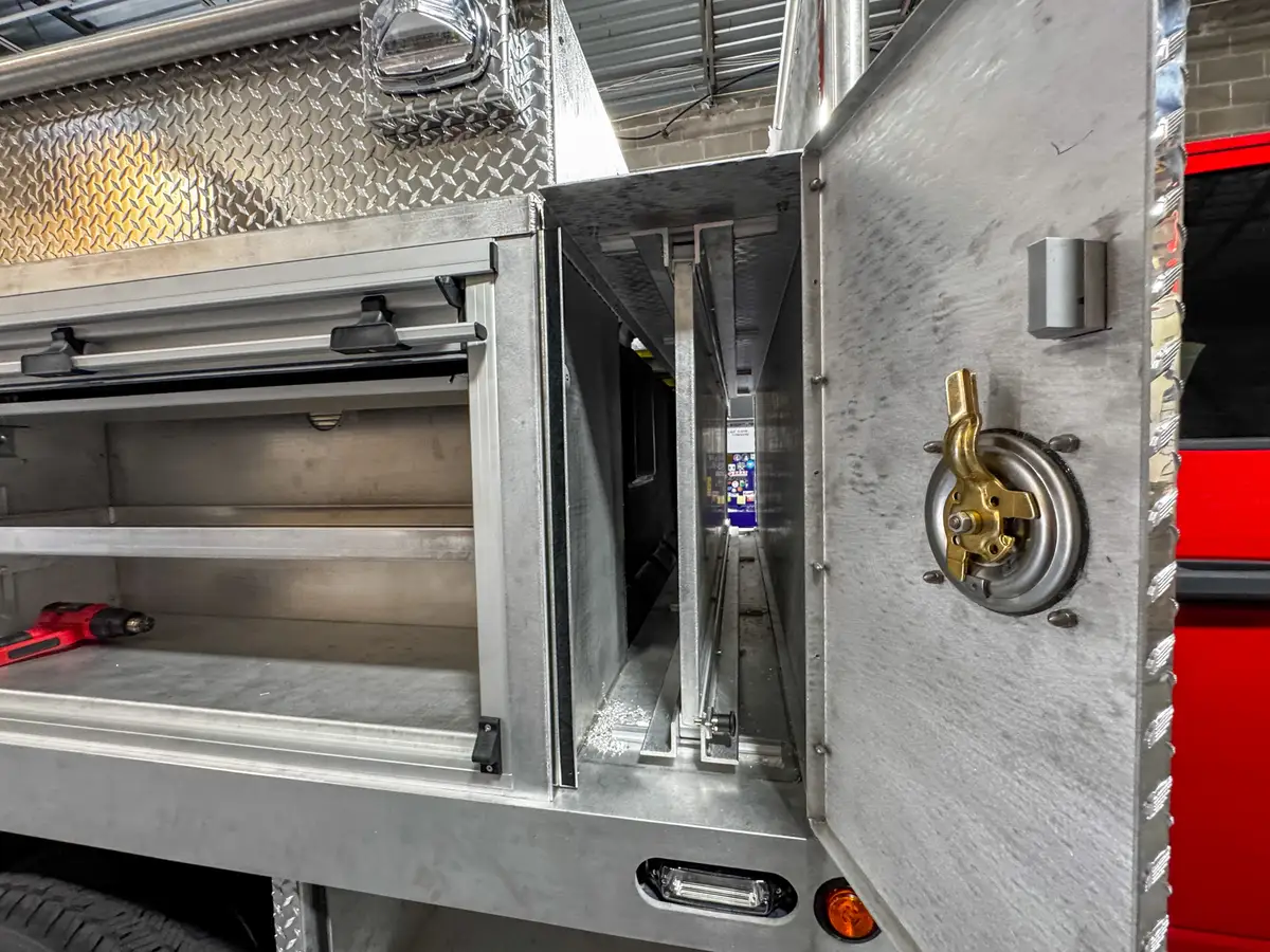 Close-up of the narrow side compartment with the vertical door open next to the shelf bay.