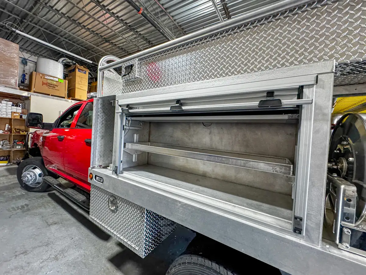 Left-side compartment view with the roll-up shelf compartment open and empty interior shelves visible.