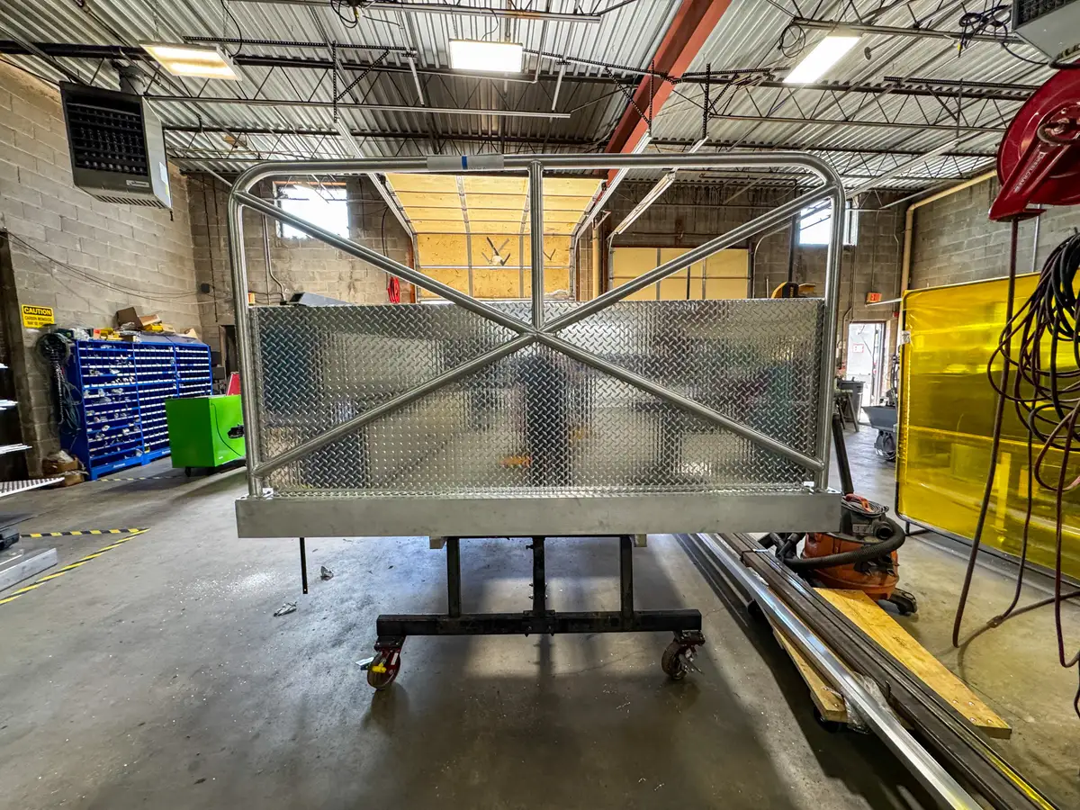 Straight rear view of the unfinished body module showing the rear panel and upper rail framework.