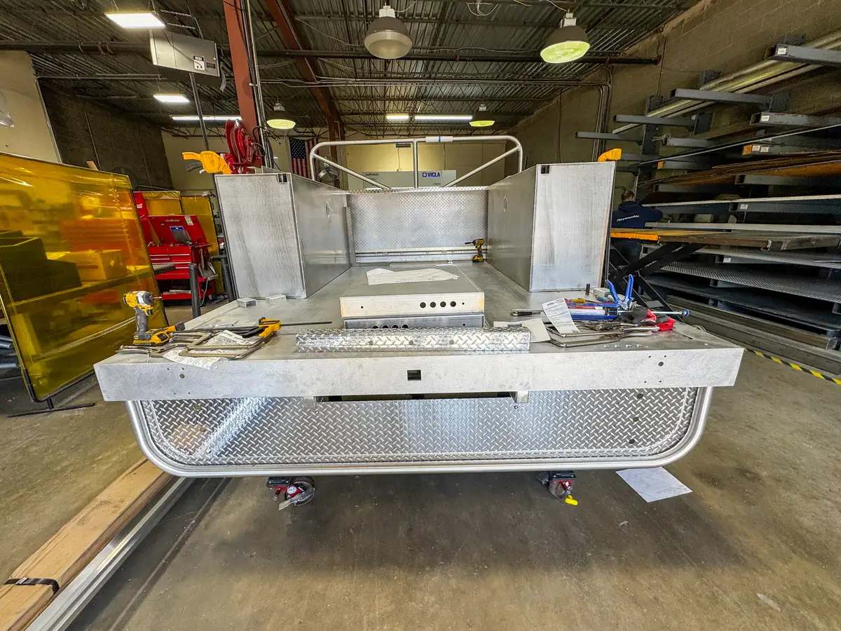 Rear deck view of the unfinished body module showing compartment partitions and front deck edge paneling.