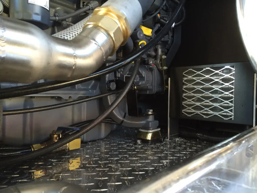 Exterior view of small fire truck showing cab, body compartments, and wheel/tire area.